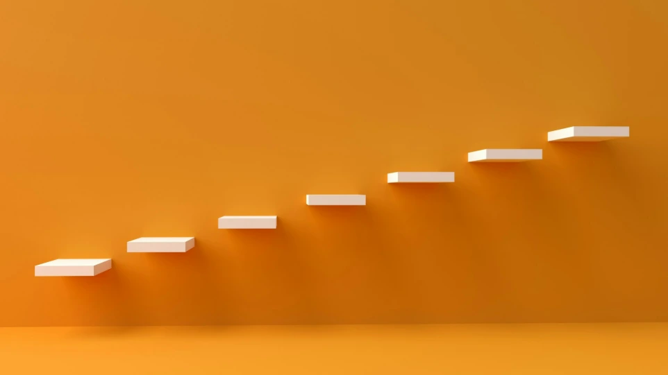 white steps rising on orange wall